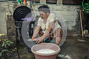 Senior asian woman washing cloths