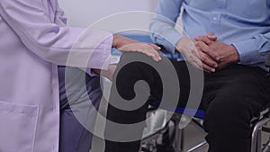 Senior Asian Women Doctor Physiotherapist treating exam old man patient's knee injury pain problem or Chiropractic