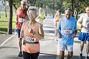 Senior athletes running together in the park photo