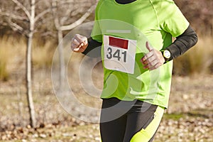 Senior athletic runner on a cross country race. Outdoor circuit