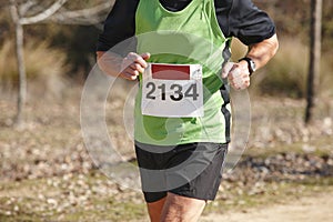 Senior athletic runner on a cross country race. Outdoor circuit