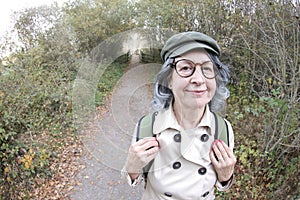 Senior backpacker following trail in nature