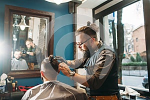 Senior barber finishing stylish hairdo free space