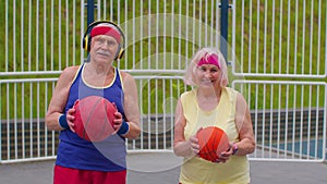 Senior basketball sport couple man woman playing ball game, practicing dribbling at stadium court