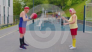 Senior basketball team couple man woman playing game with ball, pass to each other at stadium court
