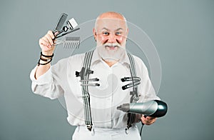 Senior bearded man, bearded old male. Portrait of vintage barber. Barber scissors and straight razor, hair dryer in