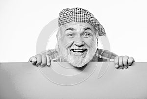 Senior bearded man peek out of banner place announcement. Advertisement shop. Pensioner grandfather in vintage hat hold