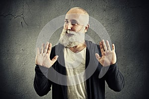 Senior bearded man showing refusal sign