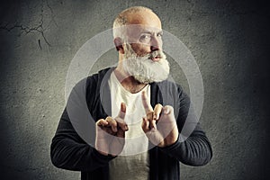 Senior bearded man showing refusal sign