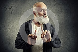 Senior bearded man showing refusal sign photo