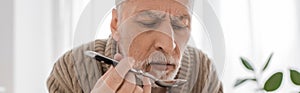 senior bearded man suffering from parkinsonism