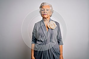 Senior beautiful grey-haired woman wearing casual dress standing over white background Relaxed with serious expression on face