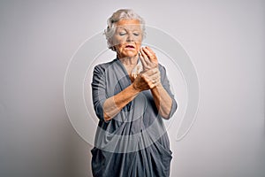 Senior beautiful grey-haired woman wearing casual dress standing over white background Suffering pain on hands and fingers,
