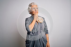 Senior beautiful grey-haired woman wearing casual dress standing over white background Thinking worried about a question,