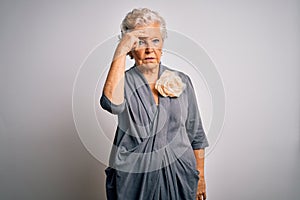 Senior beautiful grey-haired woman wearing casual dress standing over white background worried and stressed about a problem with