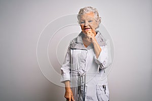 Senior beautiful grey-haired woman wearing casual jacket standing over white background looking confident at the camera with smile