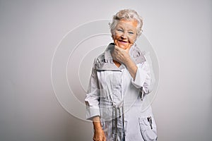 Senior beautiful grey-haired woman wearing casual jacket standing over white background looking confident at the camera smiling