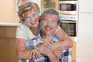Senior beautiful middle age couple around 70 years old smiling happy together at home kitchen looking sweet in lifetime husband an