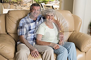 Senior beautiful middle age couple around 70 years old smiling happy together at home living room sofa couch looking sweet in life