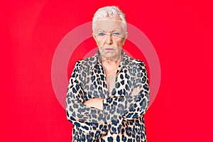 Senior beautiful woman with blue eyes and grey hair wearing casual and modern leopard animal print shirt skeptic and nervous,