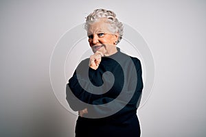 Senior beautiful woman wearing casual black sweater standing over isolated white background looking confident at the camera with