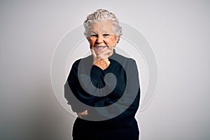 Senior beautiful woman wearing casual black sweater standing over isolated white background looking confident at the camera
