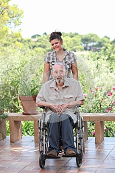 Senior being pushed in wheelchair