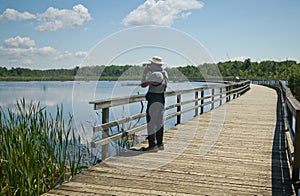 A senior bird watcher in marsh