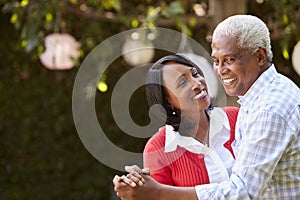 Senior black couple dancing in their backyard, close up