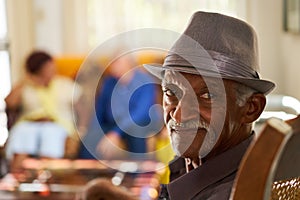 Senior Black Man With Hat Looking At Camera In Hospice