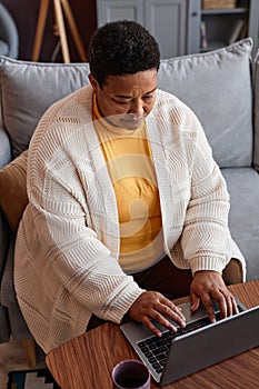 Senior black woman using laptop while working from home