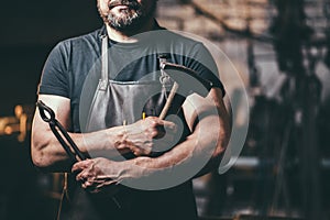 Senior blacksmith in smithy.