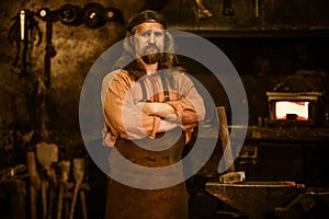 Senior blacksmith in smithy