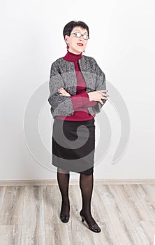 Senior buisness woman standing isolated on grey studio background photo