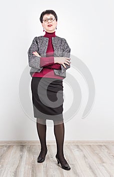 Senior buisness woman standing isolated on grey studio background photo