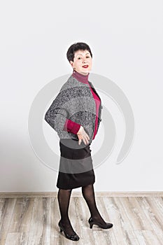 Senior buisness woman standing isolated on grey studio background photo