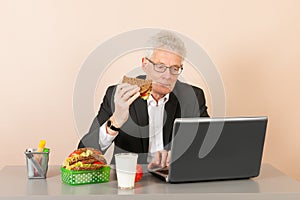 Senior business man eating bread