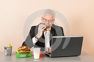 Senior business man eating bread