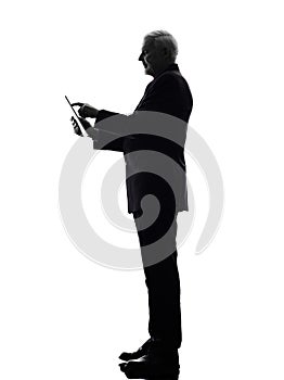 Senior business man holding digital tablet silhouette
