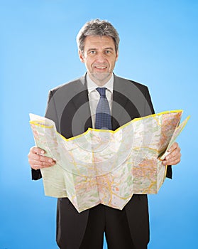 Senior business man looking into map