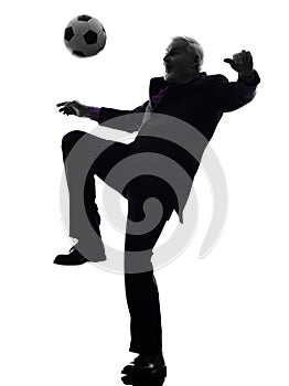 Senior business man playing soccer silhouette