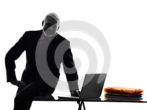 Senior business man silhouette computing