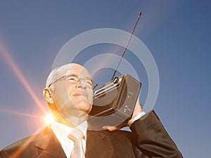 Senior business man using vintage radio