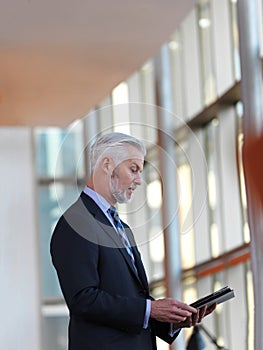 Senior business man working on tablet computer