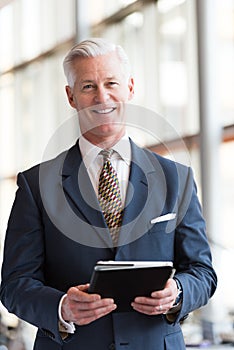 Senior business man working on tablet computer