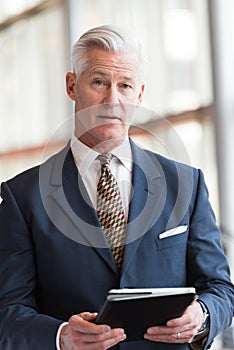 Senior business man working on tablet computer