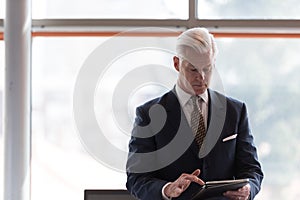 Senior business man working on tablet computer