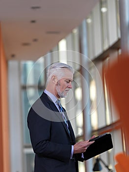 Senior business man working on tablet computer