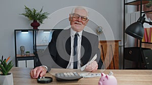 Senior business office man accountant or banker using calculator making money cash calculations