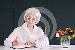 Senior business woman portrait day planning notes